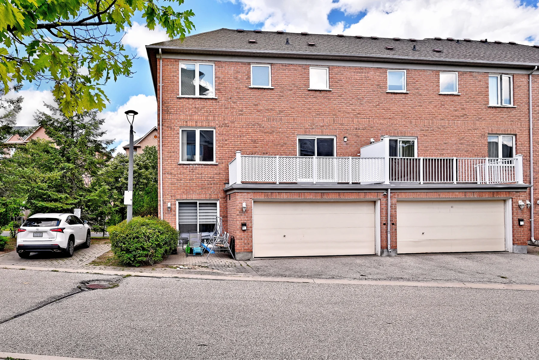 Rear exterior showing the double attached garage and side parking area