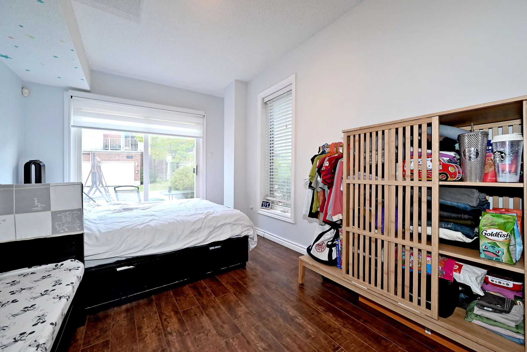 Ground-level bedroom with a walkout to the private patio